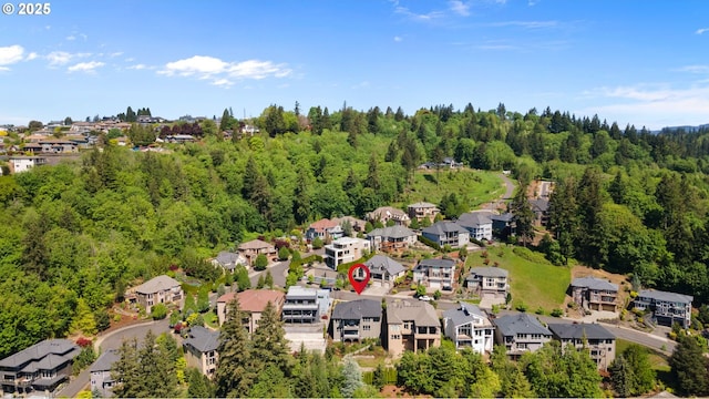aerial view featuring a wooded view and a residential view