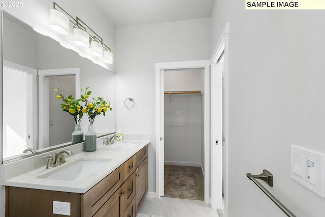 1197 NE Emerald Dr, Hermiston, OR 97838 - bathroom with double vanity, a walk in closet, and marble finish flooring