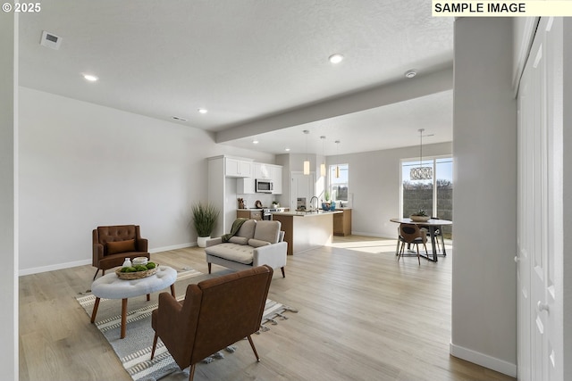1197 NE Emerald Dr, Hermiston, OR 97838 - living area with light wood-style floors and recessed lighting