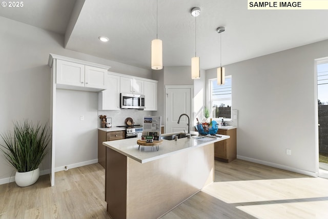 1197 NE Emerald Dr, Hermiston, OR 97838 - kitchen with stainless steel appliances, light wood-type flooring, white cabinetry, light countertops, and recessed lighting