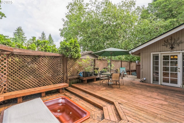 wooden terrace with outdoor dining space and fence