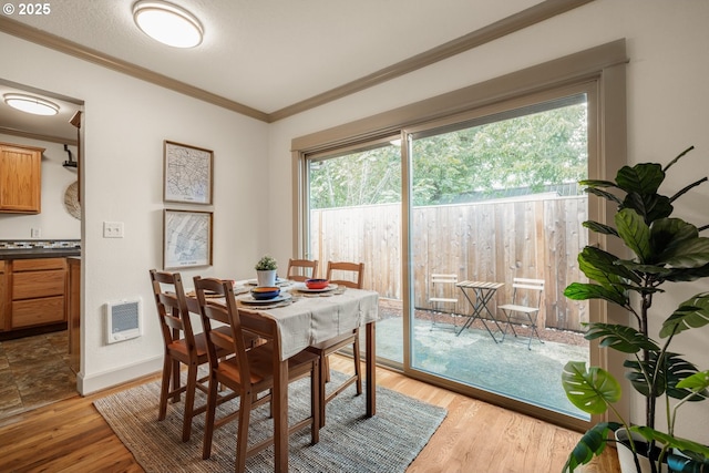 9334 N Lombard St Unit 7, Portland, OR 97203 - dining space with crown molding and light wood-style floors
