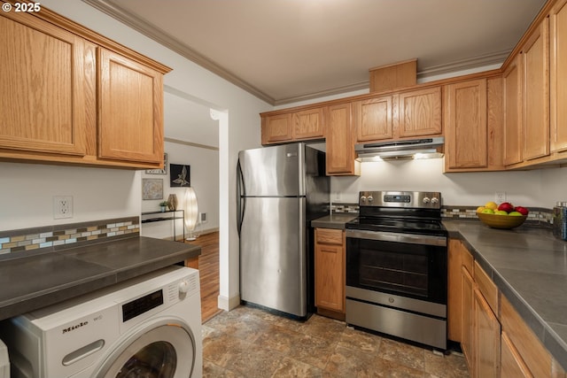 9334 N Lombard St Unit 7, Portland, OR 97203 - kitchen with appliances with stainless steel finishes, under cabinet range hood, washer / dryer, dark countertops, and ornamental molding