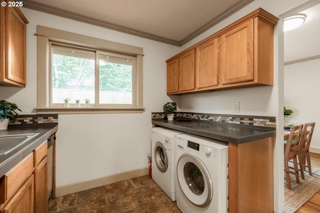 9334 N Lombard St Unit 7, Portland, OR 97203 - laundry room featuring separate washer and dryer, cabinet space, crown molding, and dark stone finish floors