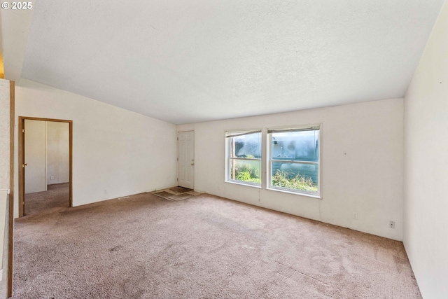 carpeted empty room with a textured ceiling
