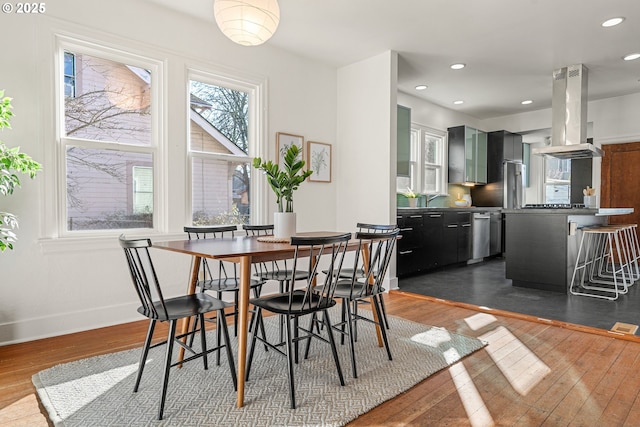 dining room with dark wood-style floors, baseboards, and recessed lighting