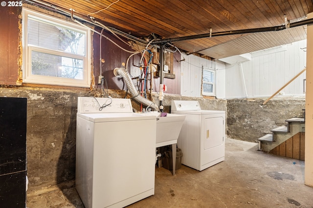 laundry area featuring a sink, laundry area, washing machine and dryer, and wood ceiling