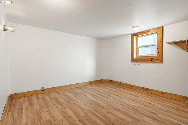 unfurnished room featuring light wood-type flooring and baseboards