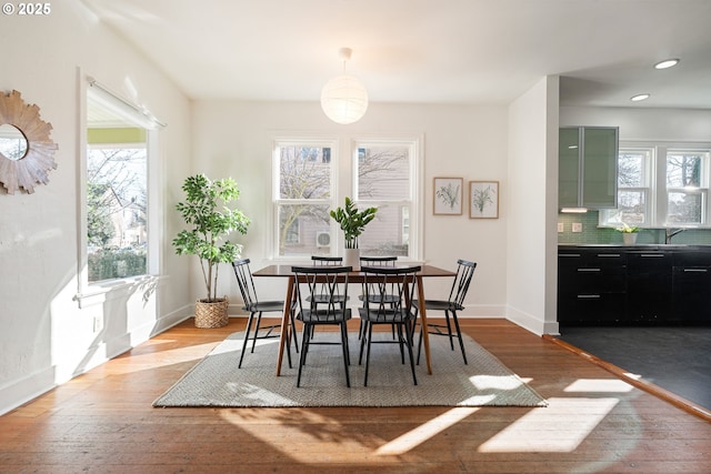 dining room featuring wood-type flooring, baseboards, and recessed lighting