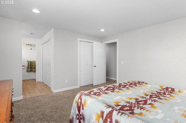 bedroom featuring carpet flooring, recessed lighting, baseboards, and ensuite bath
