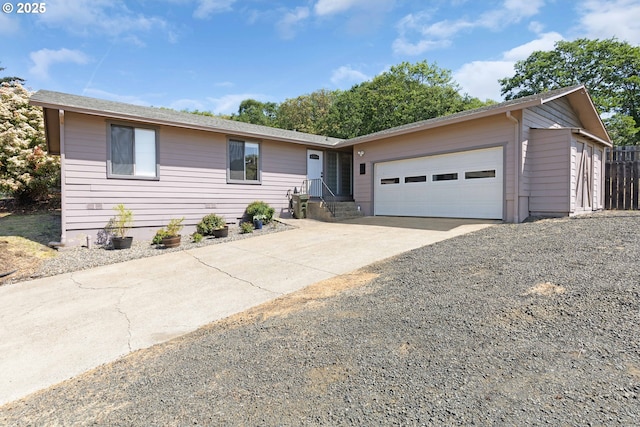 ranch-style house featuring driveway and a garage