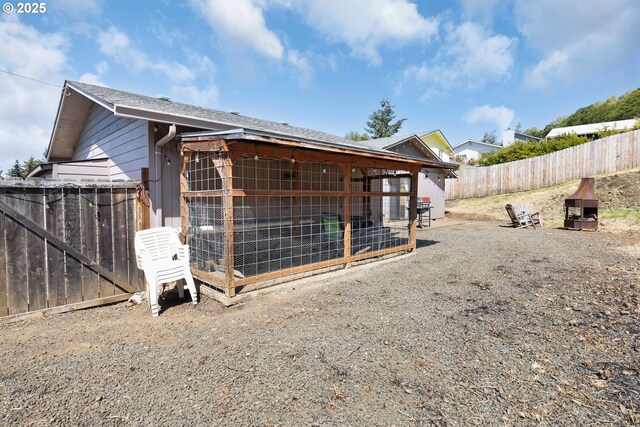 view of side of property with a fenced backyard, exterior structure, and an outdoor structure