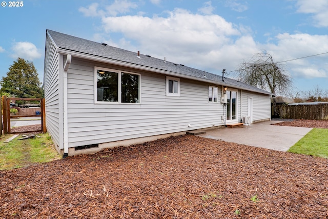 rear view of property with a patio area, fence, and roof with shingles