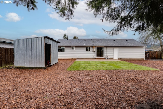 back of house with an outbuilding, a patio area, and fence