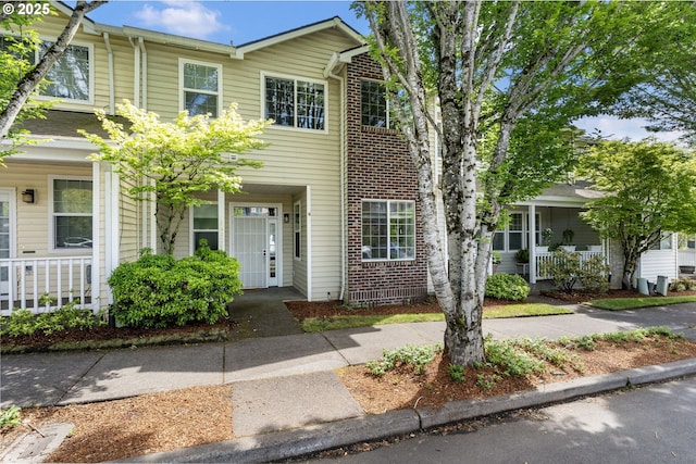14426 SE Princeton Village Way, Clackamas, OR 97015 - townhome / multi-family property with covered porch and brick siding