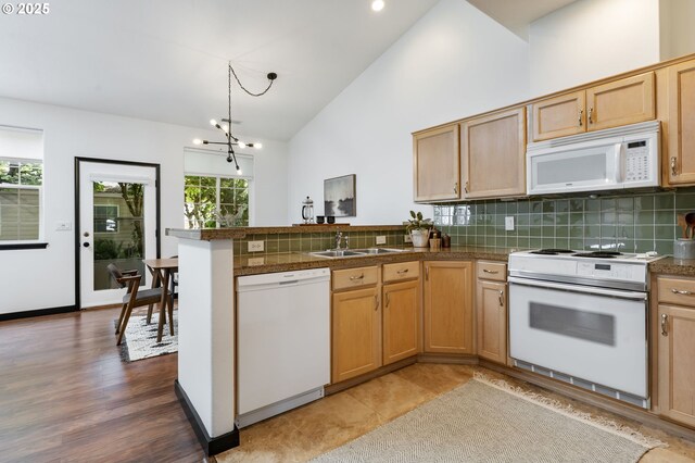 14426 SE Princeton Village Way, Clackamas, OR 97015 - kitchen with white appliances, a peninsula, tile countertops, backsplash, and high vaulted ceiling