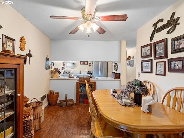 dining room with a ceiling fan and wood finished floors
