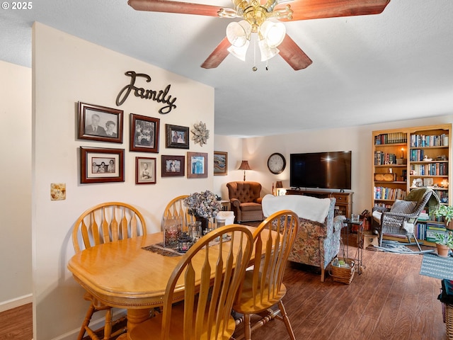 dining room featuring wood finished floors, ceiling fan, and baseboards