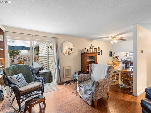 720 SE Rene Ave, Gresham, OR 97080 - living room with ceiling fan, wood finished floors, and a textured ceiling