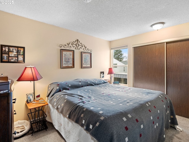 carpeted bedroom featuring a closet and a textured ceiling
