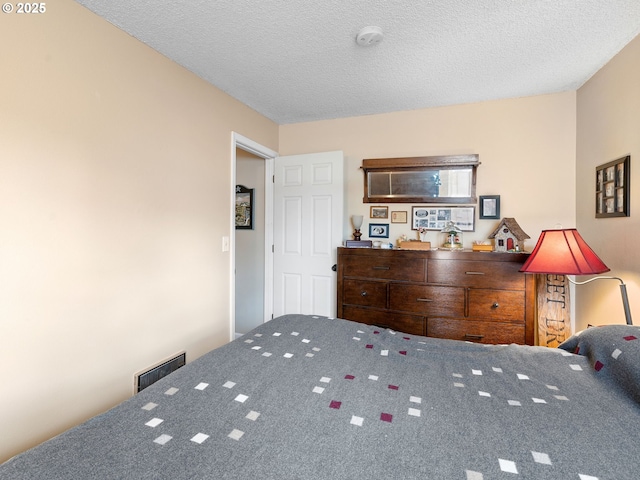 carpeted bedroom featuring a textured ceiling