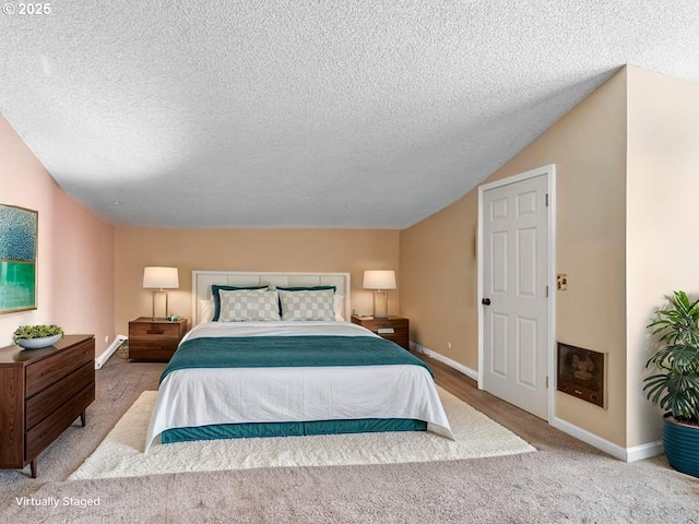 bedroom with carpet, a textured ceiling, and baseboards