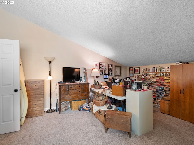 carpeted office featuring vaulted ceiling and a textured ceiling