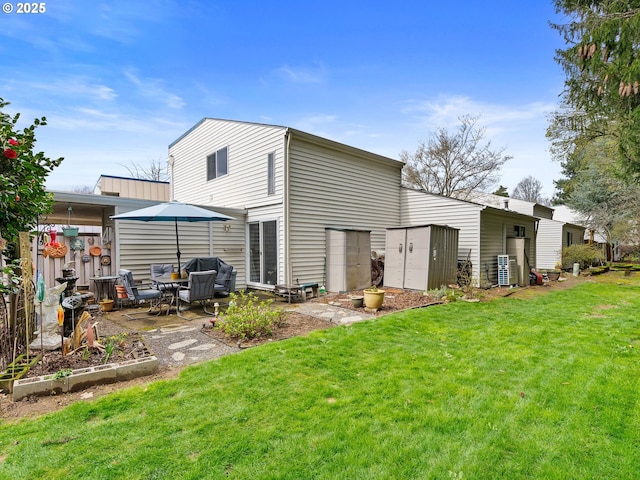 back of property with a yard and a patio area