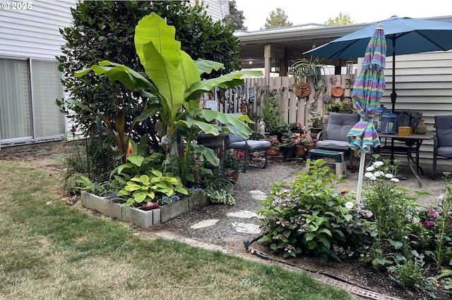 view of yard with fence and a vegetable garden