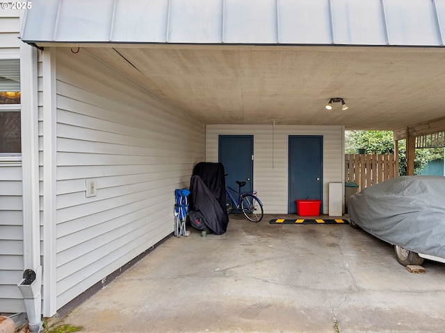 view of patio with fence and a carport