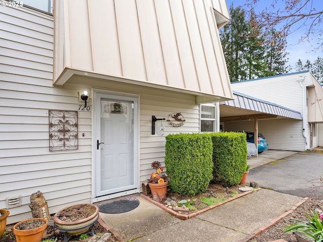 720 SE Rene Ave, Gresham, OR 97080 - doorway to property featuring driveway, an attached carport, and board and batten siding