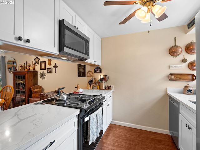 720 SE Rene Ave, Gresham, OR 97080 - kitchen with stainless steel appliances, ceiling fan, wood finished floors, white cabinetry, and light stone counters