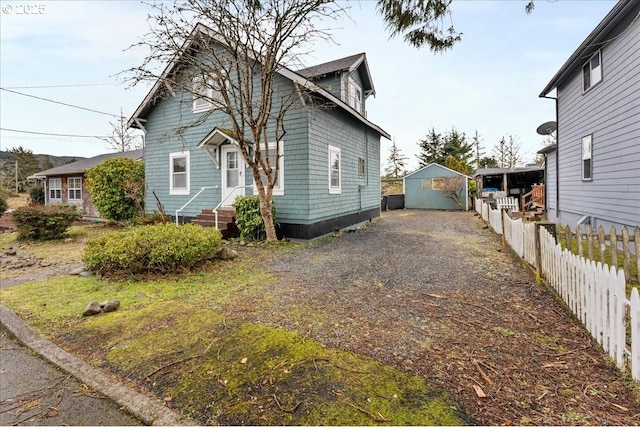 view of front of home with a garage and an outdoor structure