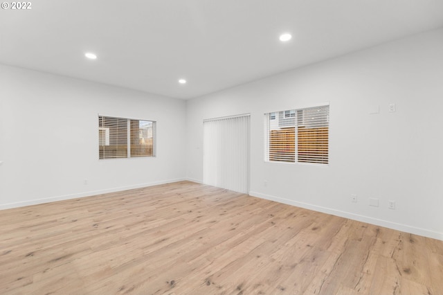unfurnished room with recessed lighting, baseboards, and light wood-style flooring