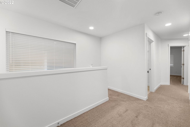 carpeted spare room featuring recessed lighting, baseboards, and visible vents