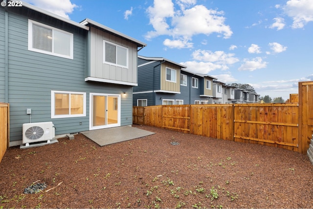 back of house featuring ac unit, board and batten siding, a fenced backyard, and a residential view