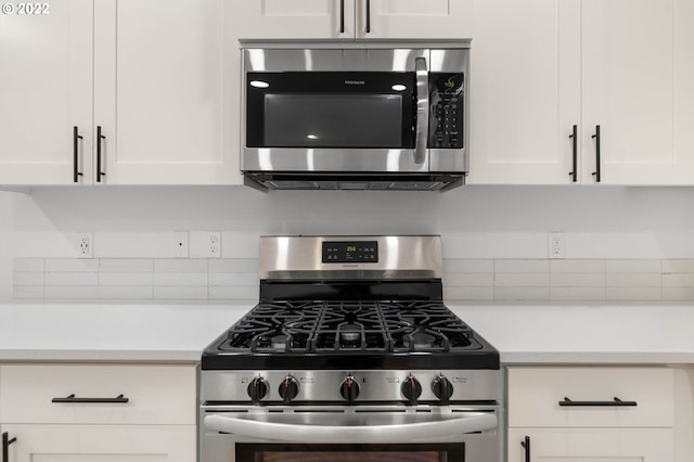 kitchen with light countertops, white cabinetry, appliances with stainless steel finishes, and backsplash