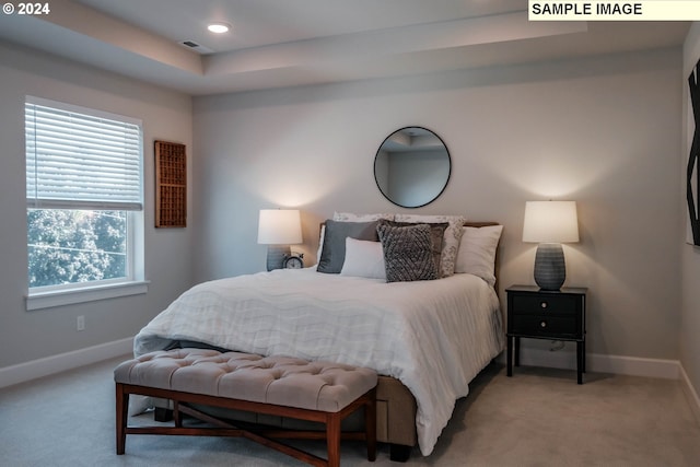 bedroom featuring baseboards, visible vents, and light colored carpet