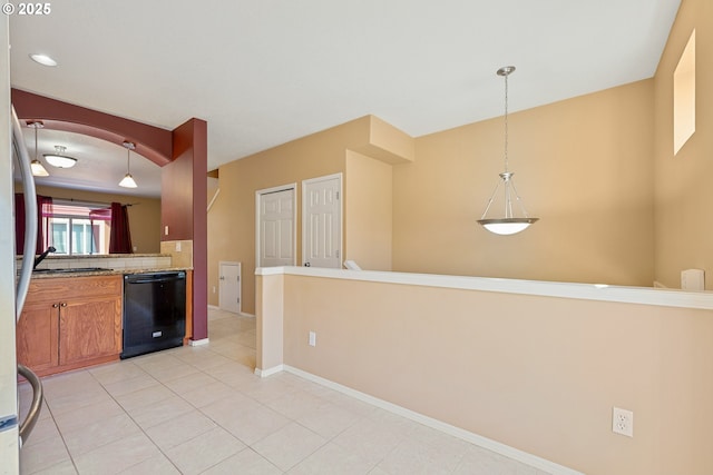17047 SW Berkeley Ln, Beaverton, OR 97003 - kitchen featuring black dishwasher, light tile patterned floors, hanging light fixtures, baseboards, and brown cabinetry