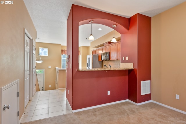 17047 SW Berkeley Ln, Beaverton, OR 97003 - kitchen featuring black microwave, stainless steel fridge with ice dispenser, tasteful backsplash, light stone counters, and baseboards