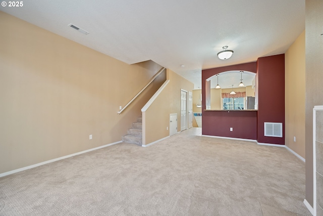 17047 SW Berkeley Ln, Beaverton, OR 97003 - unfurnished living room with carpet flooring, stairs, and baseboards