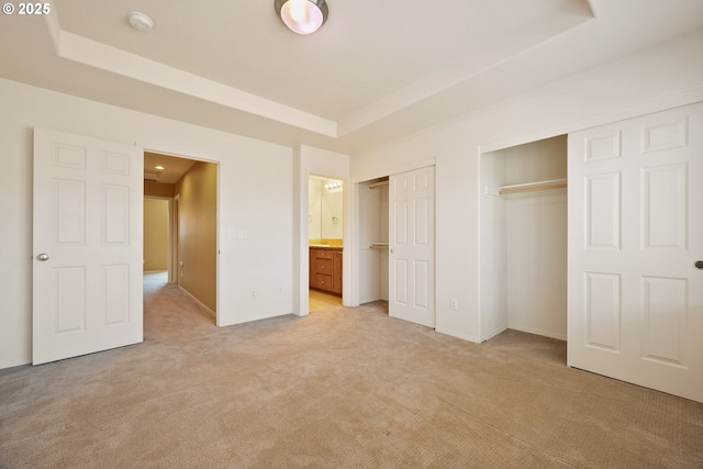 17047 SW Berkeley Ln, Beaverton, OR 97003 - unfurnished bedroom with a tray ceiling, light colored carpet, two closets, and ensuite bath