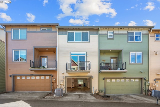 17047 SW Berkeley Ln, Beaverton, OR 97003 - townhome / multi-family property featuring an attached garage, board and batten siding, cooling unit, and driveway