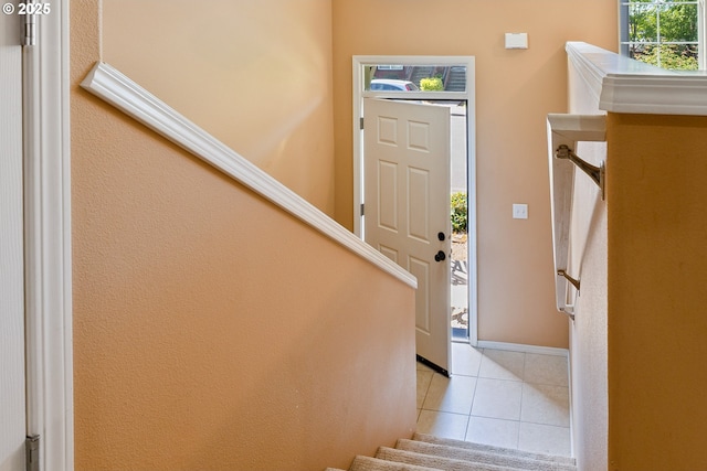 17047 SW Berkeley Ln, Beaverton, OR 97003 - foyer entrance with light tile patterned flooring, stairs, and baseboards