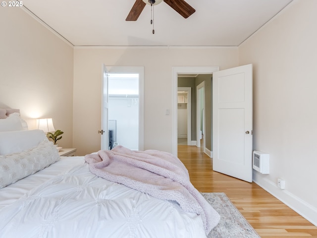 2015 NW Flanders St Unit 511, Portland, OR 97209 - bedroom with light wood finished floors, a walk in closet, and a ceiling fan