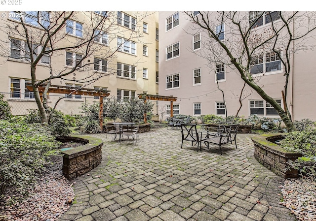 2015 NW Flanders St Unit 511, Portland, OR 97209 - view of home's community featuring outdoor dining area, a patio, and a pergola