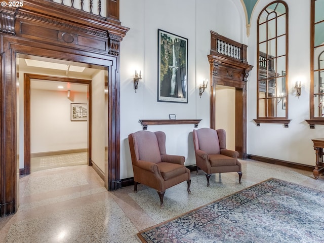 2015 NW Flanders St Unit 511, Portland, OR 97209 - living area featuring speckle patterned floor, baseboards, and a high ceiling