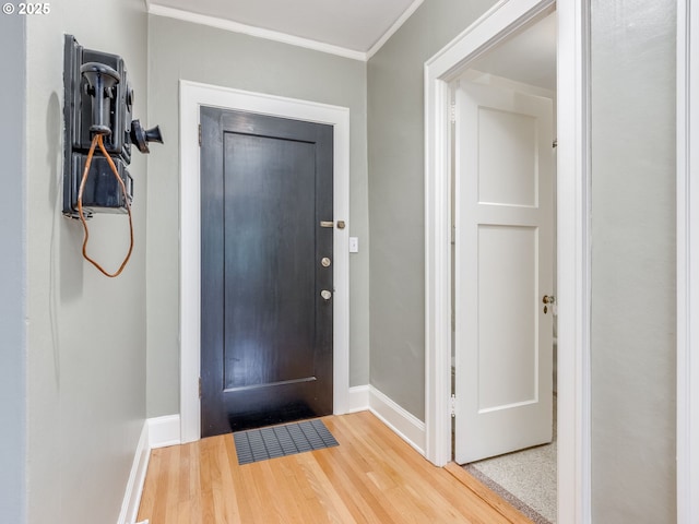2015 NW Flanders St Unit 511, Portland, OR 97209 - entrance foyer featuring baseboards, wood finished floors, and crown molding