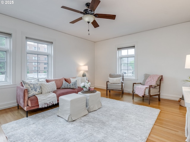 2015 NW Flanders St Unit 511, Portland, OR 97209 - living area with light wood finished floors, a ceiling fan, and baseboards