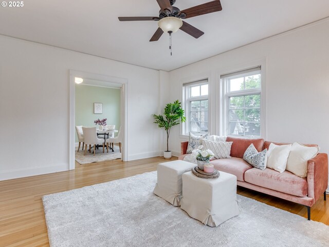 2015 NW Flanders St Unit 511, Portland, OR 97209 - living room with wood finished floors, a ceiling fan, and baseboards